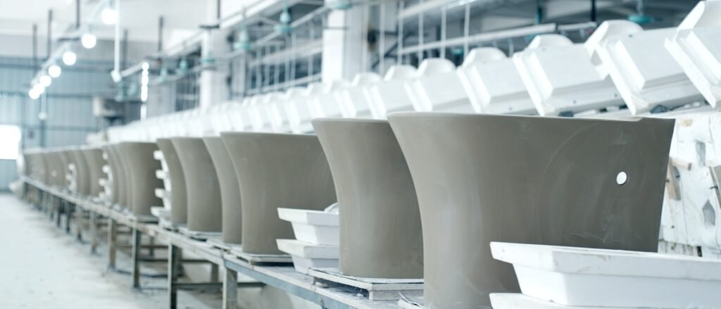 Rows of greenware basins moving along the casting line at our own ceramic sanitaryware plant in Chaozhou, China